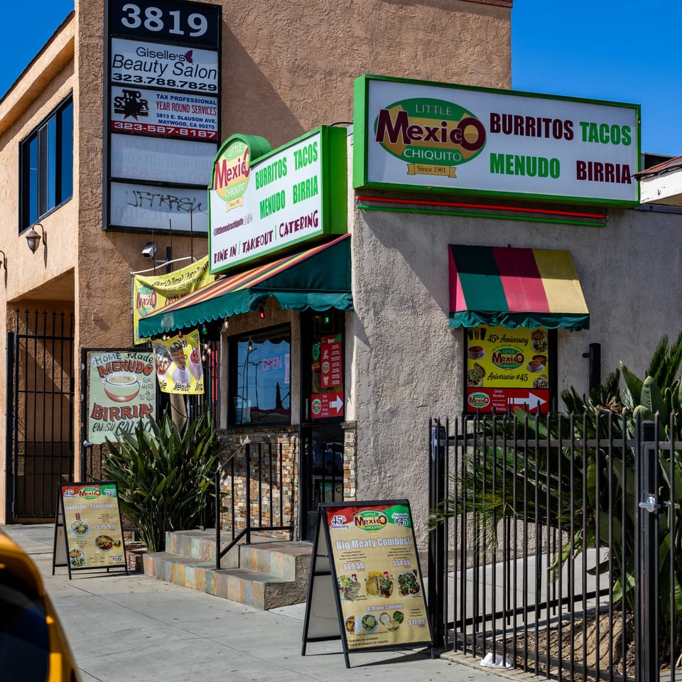 Little Mexico Chiquito restaurant exterior with signs for burritos, tacos, menudo, and birria, and specials.