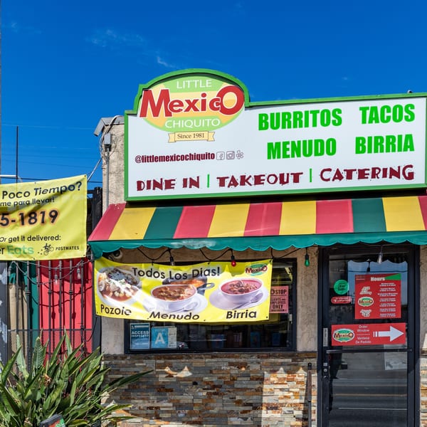 The exterior of Little Mexico Chiquito restaurant, featuring its logo, menu, and vibrant red and yellow awning.