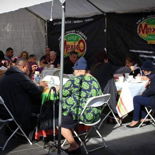 Customers dining under a tent with the Little Mexico Chiquito logo visible in the background.